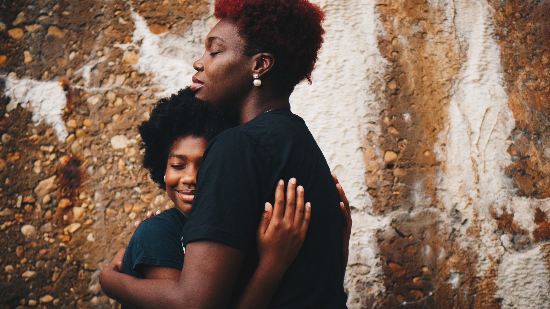 Parent and child hugging; Photo by Eye for Ebony on Unsplash