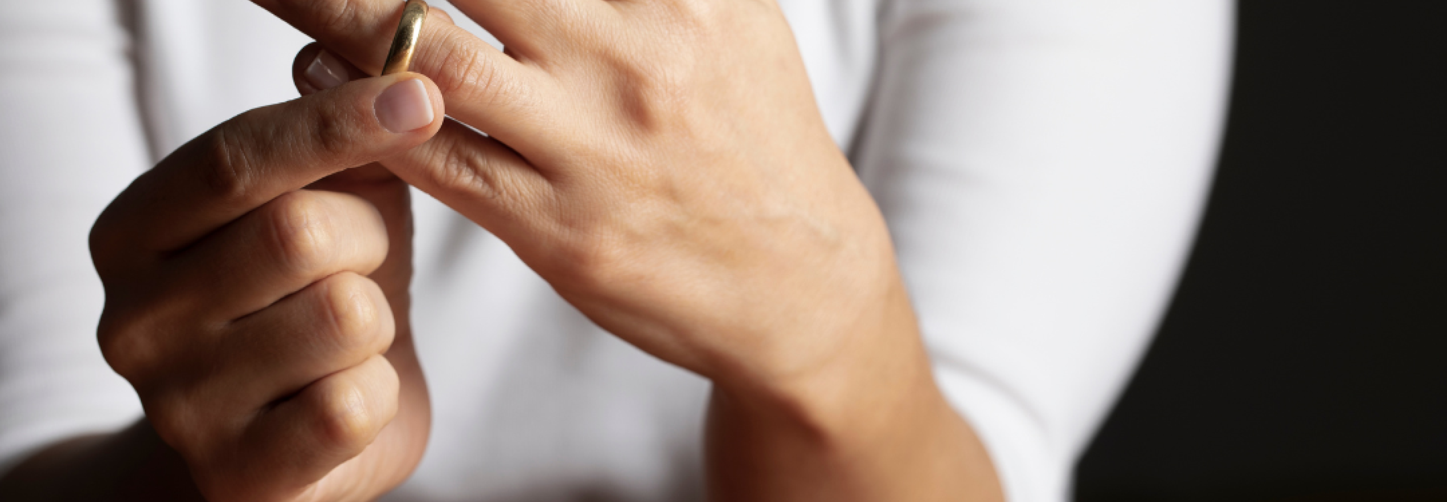 A woman removes her wedding ring