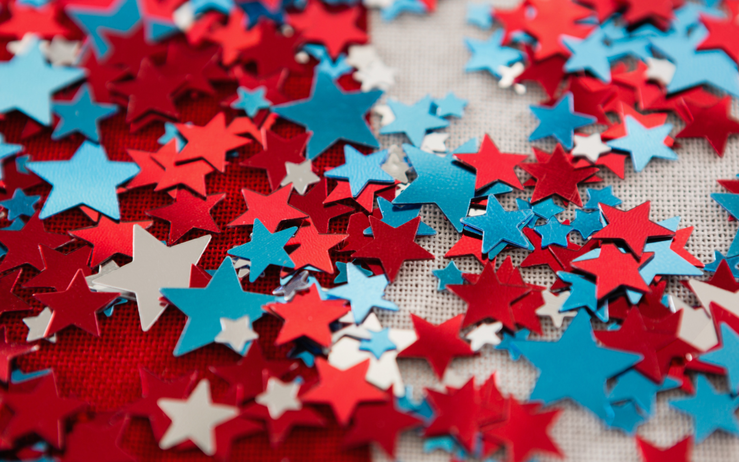 Red white and blue confetti in the shape of stars