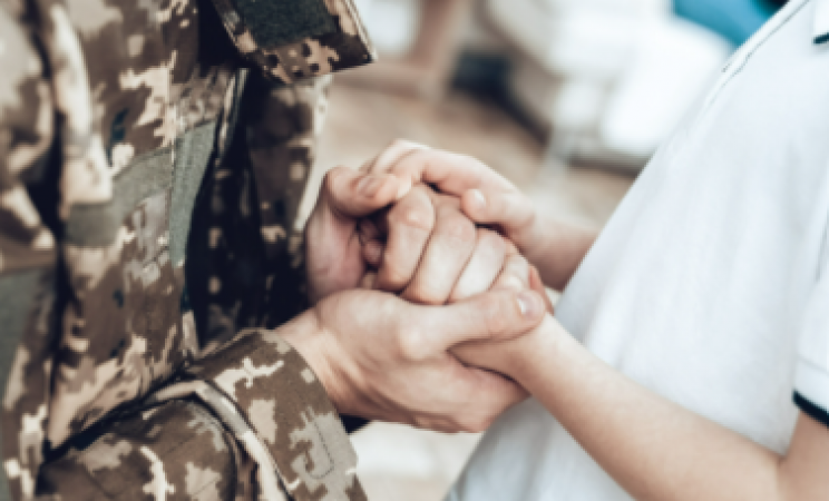 veteran holding the hands of a civilian
