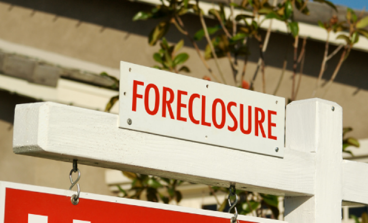 A red and white sign reads "foreclosure"
