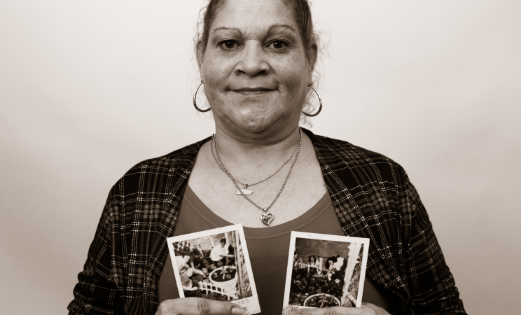 Melinda Martinez poses with two photos of her family's beloved side yard