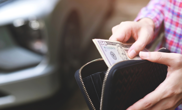 A man looks through the money in his wallet