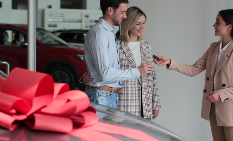a straight couple buys a car with a big bow on it