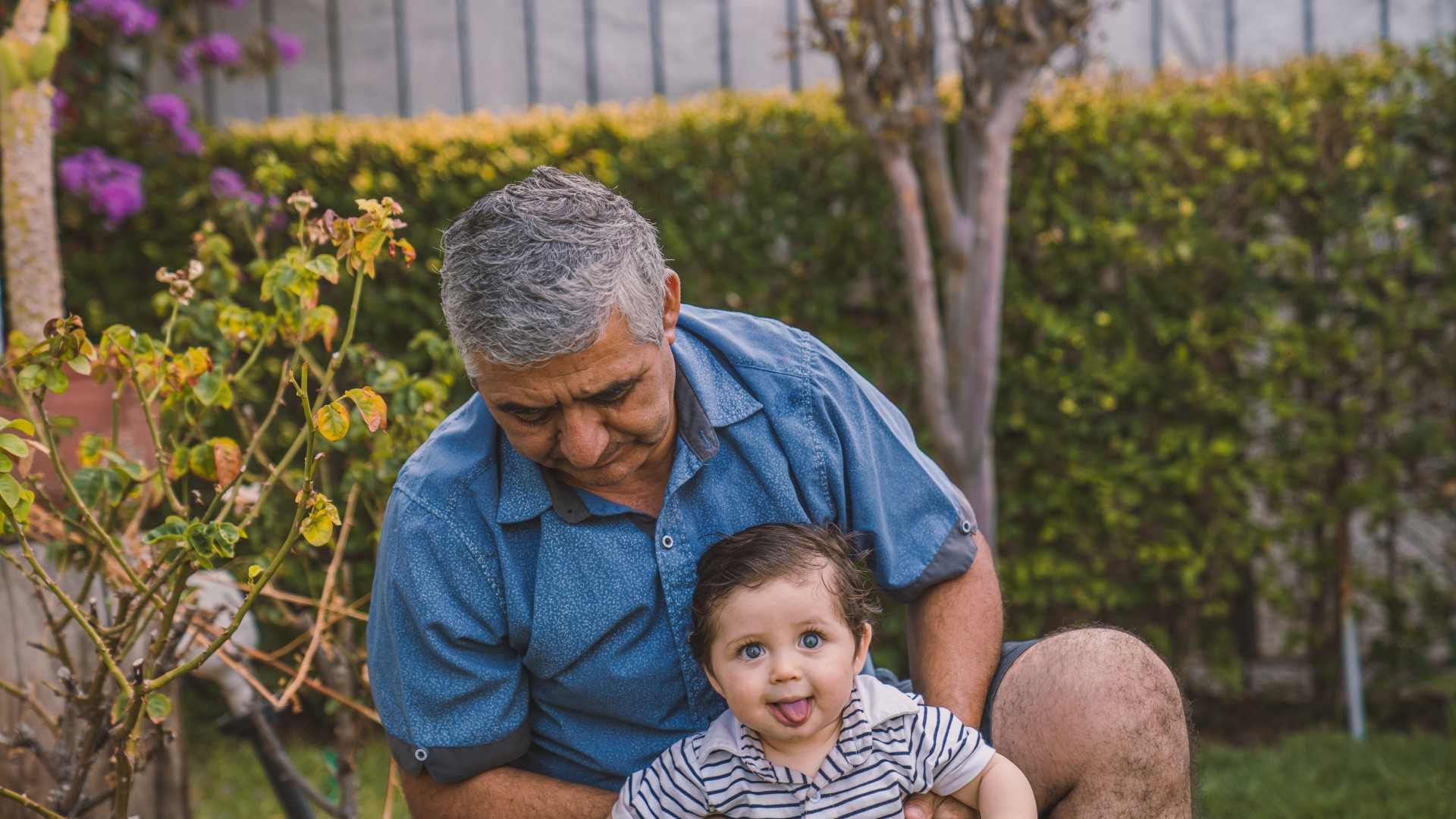 Grandfather holding his grandson; Photo from alvaro-reyes on Unsplash