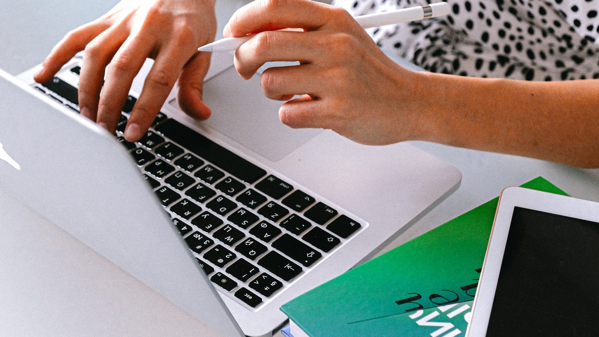 Woman in polka dot shirt filling out an application on a computer; Photo by Anna Shvets from Pexels