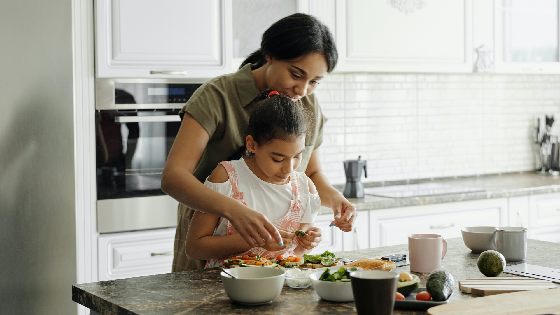 Mother and child prepare lunch together in a sunny kitchen; Photo by August de Richelieu from Pexels