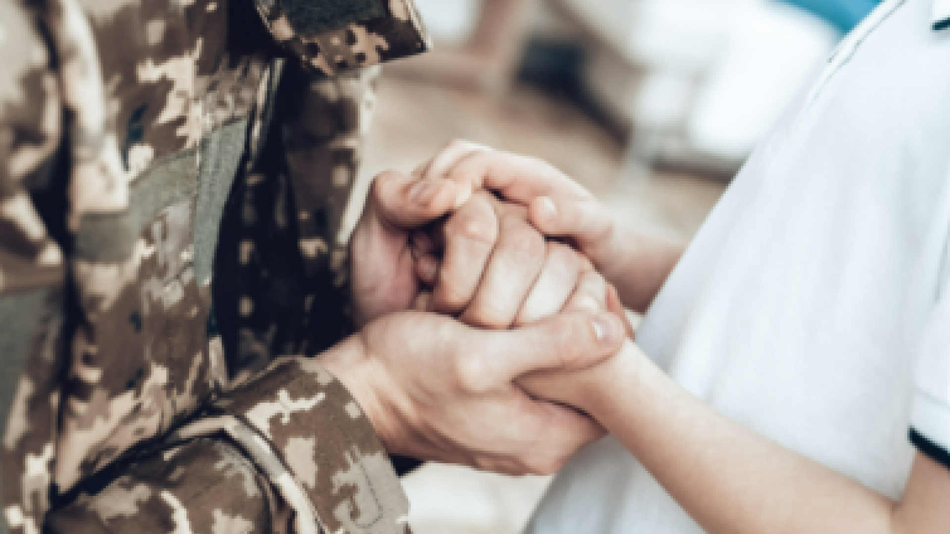 active duty military holding civilians hands 