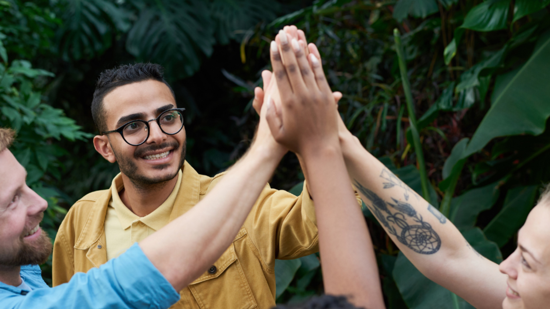 Four young people high five