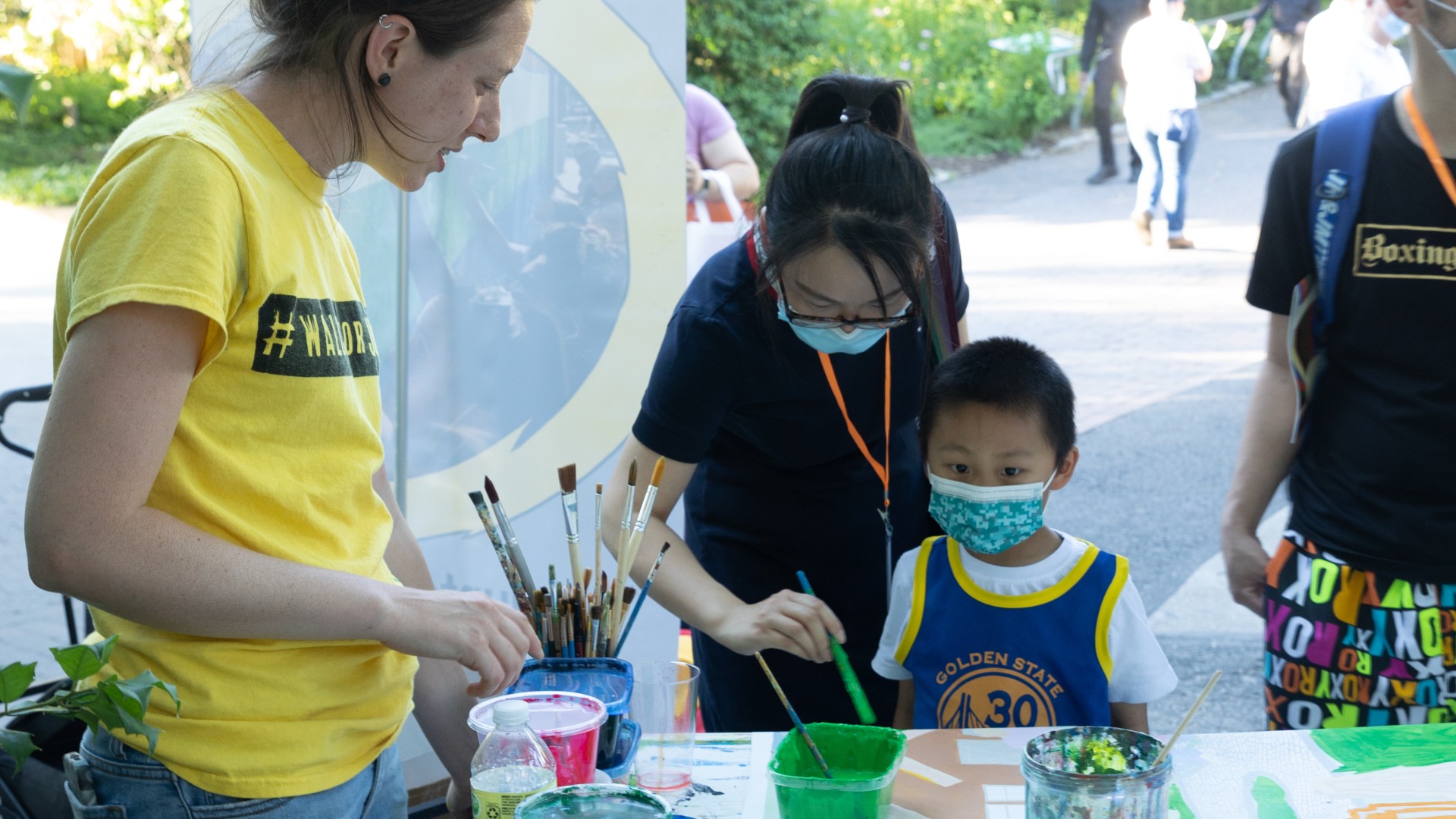 A child helps paint the mural at our Jubilee for Justice event