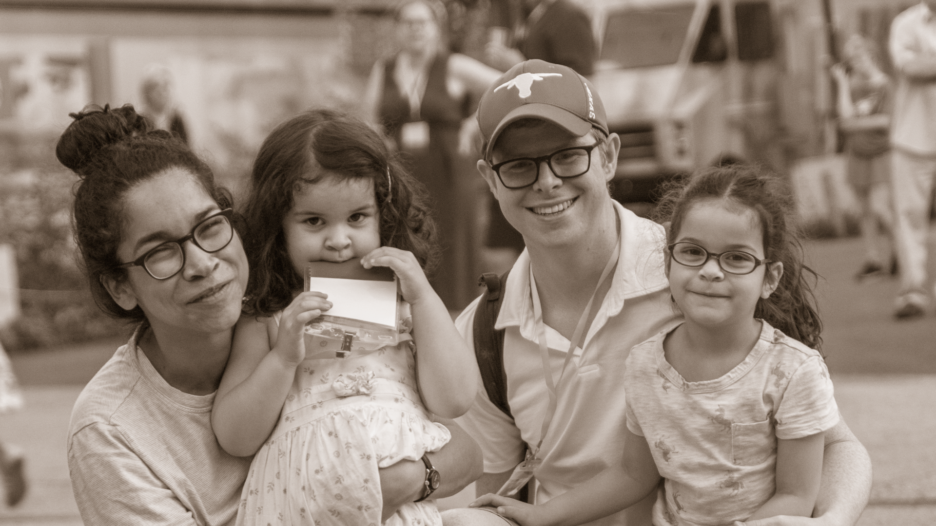 A family that includes a mother, father, and two young daughters poses for a picture at the Jubilee for Justice