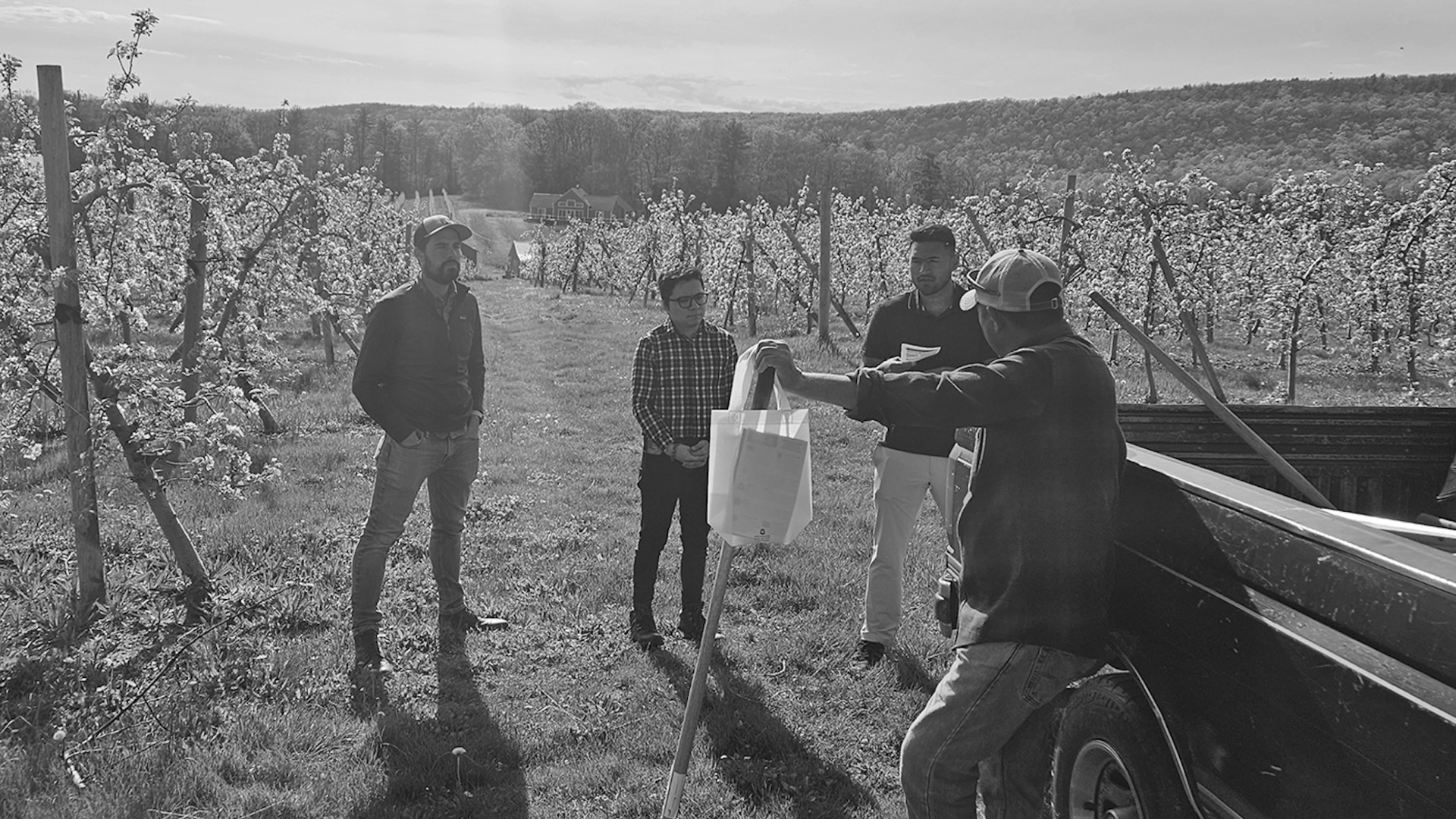 PFP staff in a farm field doing outreach