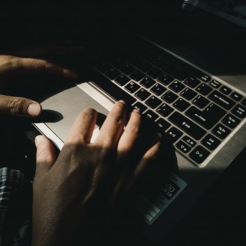Photo of hands typing on a laptop; Photo by Yudi Indrawan on Unsplash