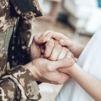 veteran holding the hands of a civilian 