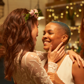 Two women slow dance at their wedding together