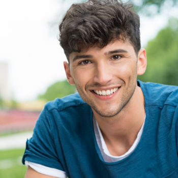 A photo of a young man smiling at the camera