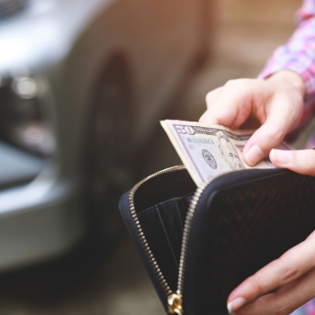 A man looks through the money in his wallet