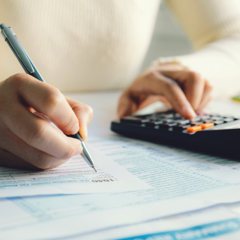 a woman uses a calculator to do her taxes