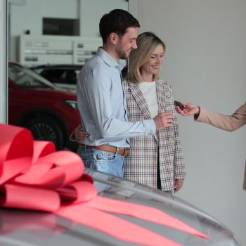 a straight couple buys a car with a big bow on it